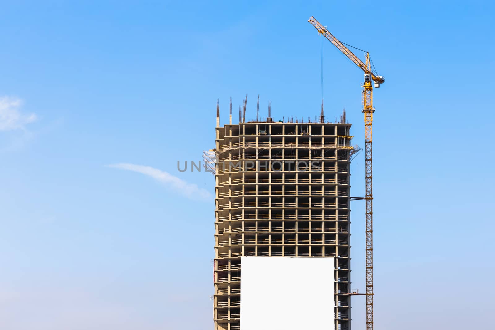 Construction crane on building site on sky background