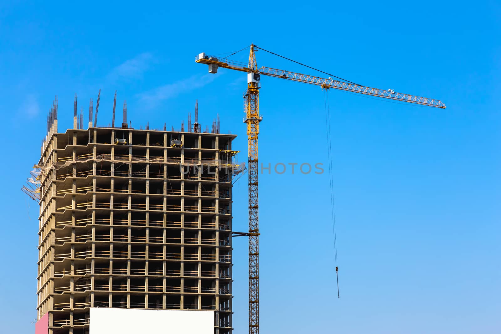 Construction crane on building site on sky background