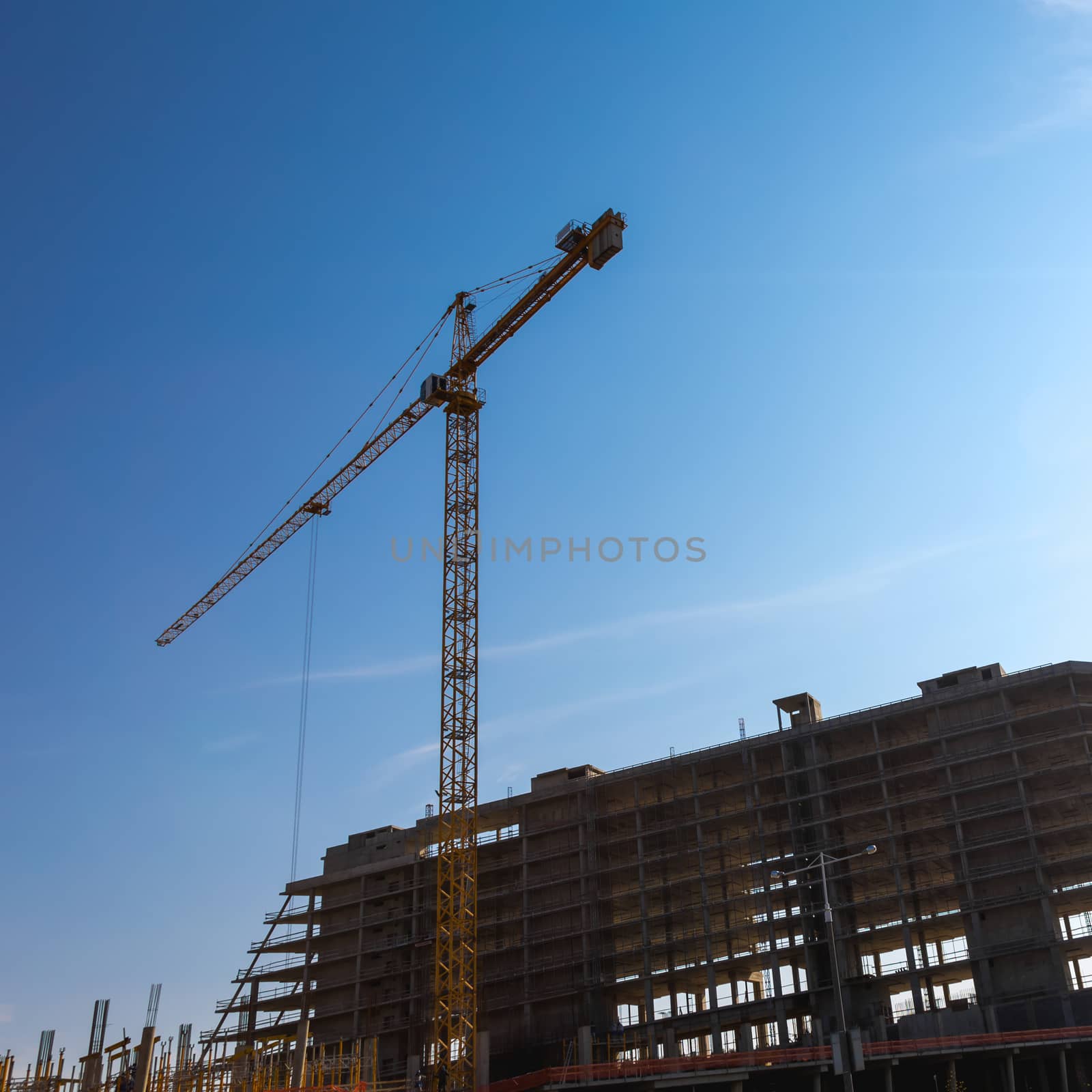 Construction crane on building site on sky background