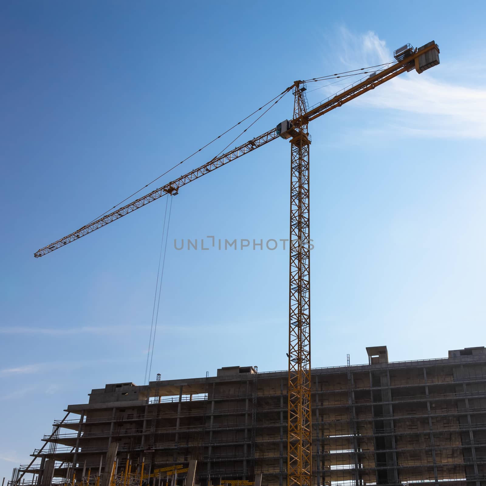 Construction crane on building site on sky background