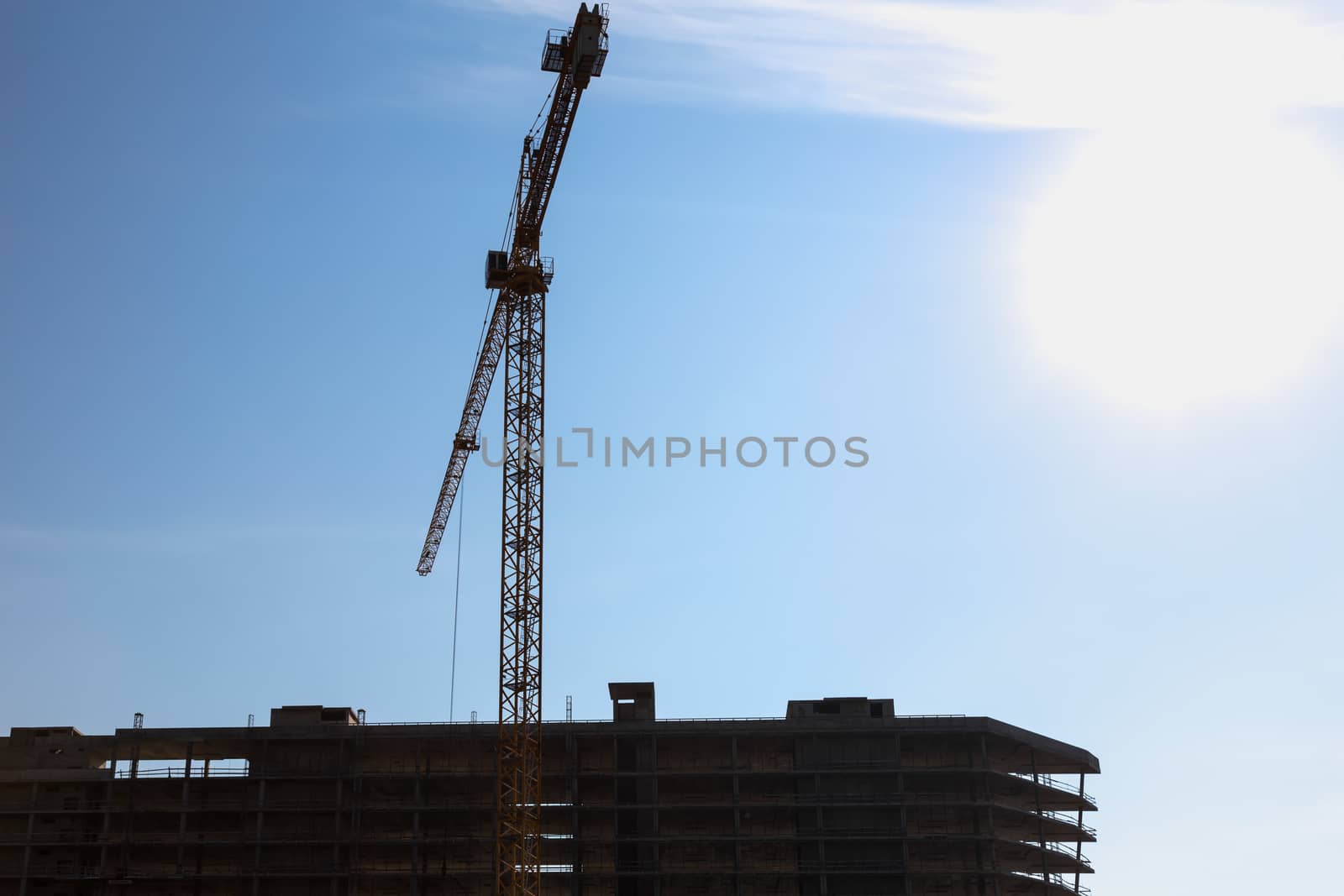 Construction crane on building site on sky background