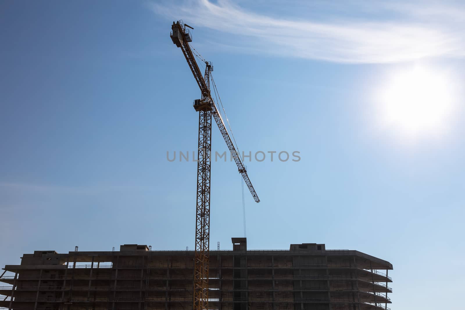 Construction crane on building site on sky background