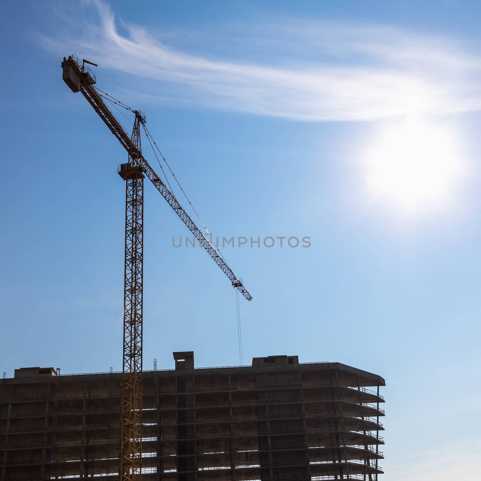 Construction crane on building site on sky background