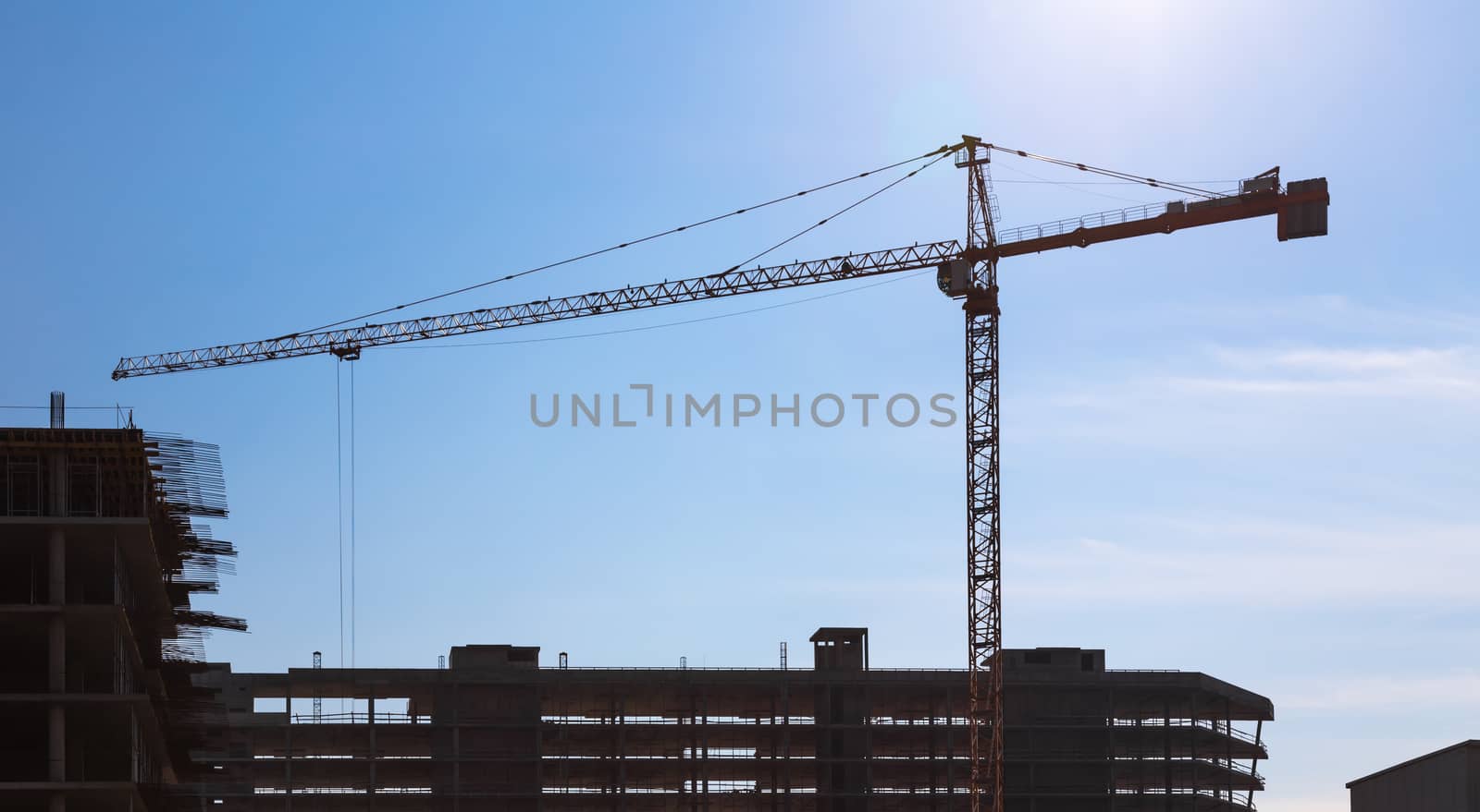 Construction crane on building site on sky background