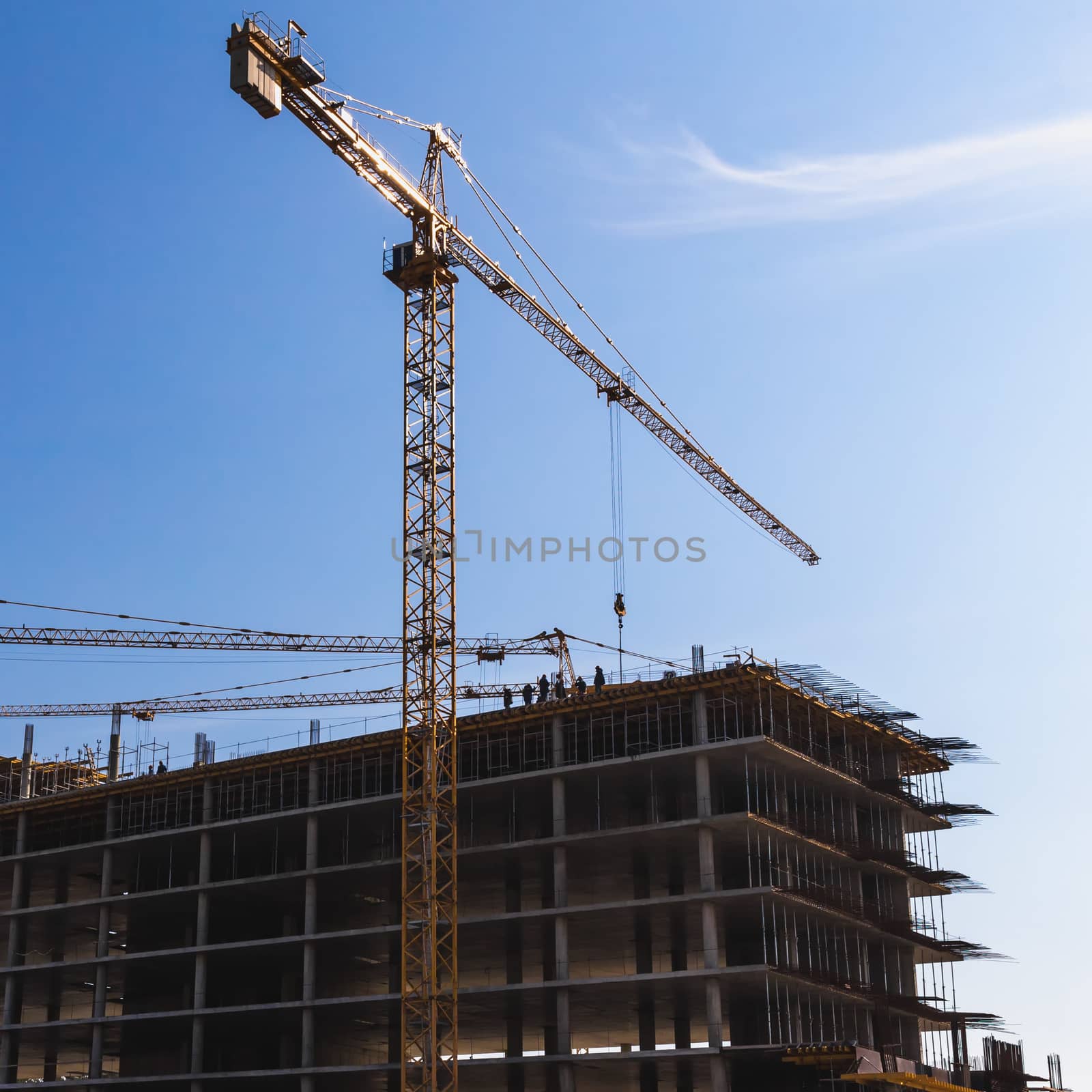 Construction crane on building site on sky background