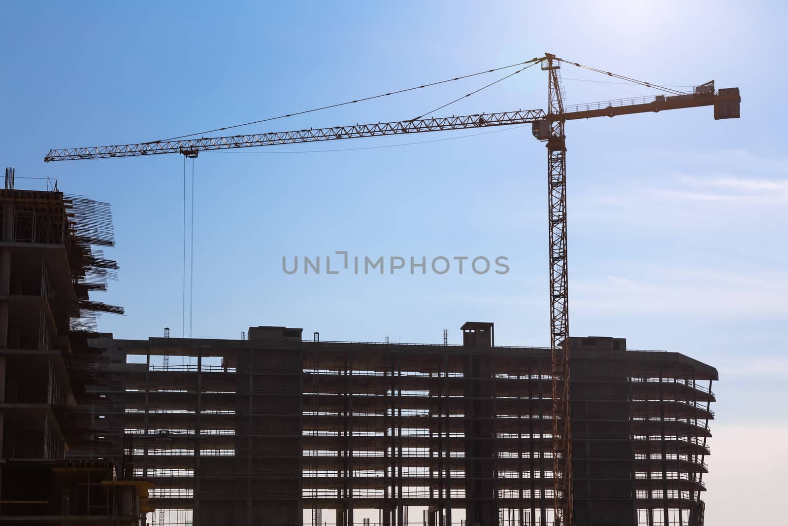 Construction crane on building site on sky background