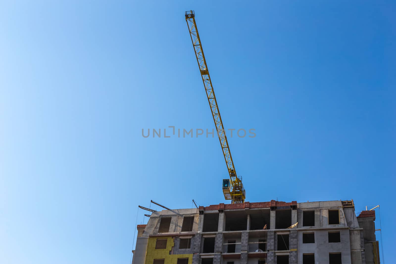 Construction crane on building site on sky background