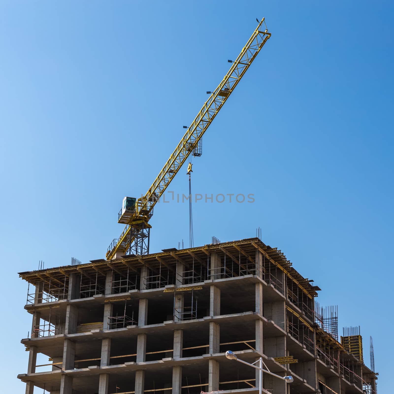 Construction crane on building site on sky background