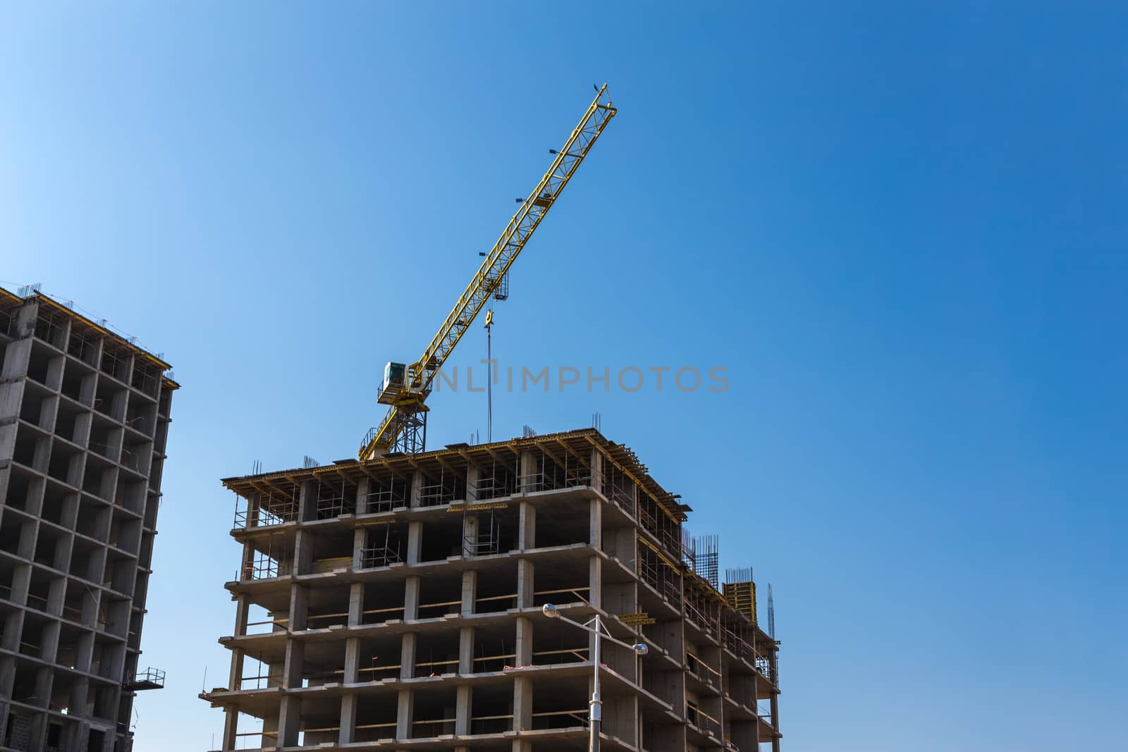 Construction crane on building site on sky background
