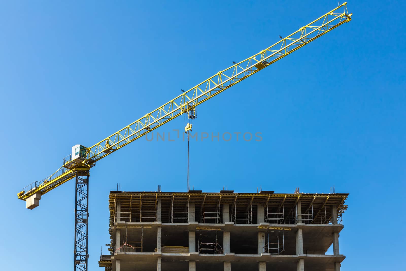 Construction crane on building site on sky background