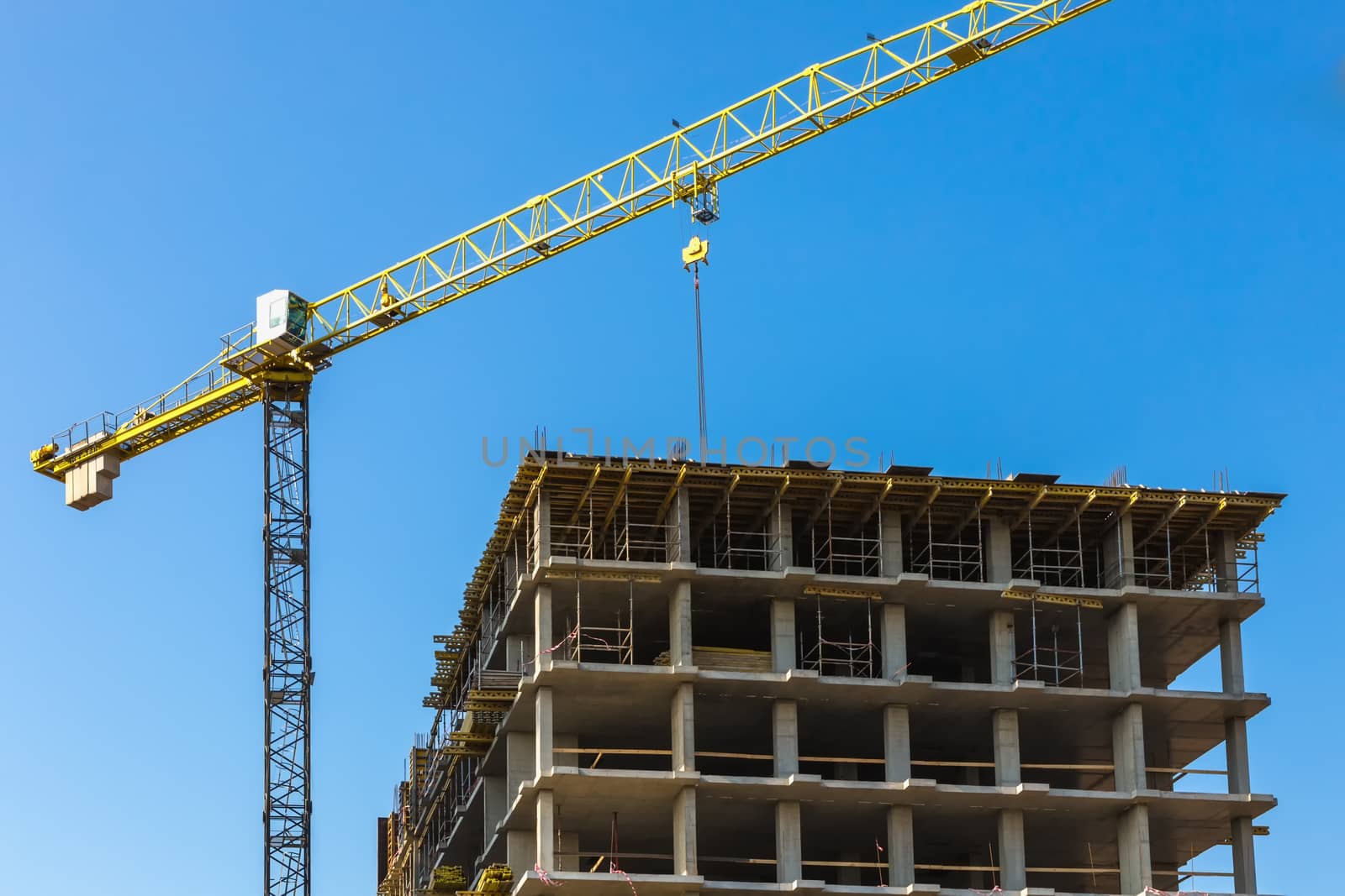 Construction crane on building site on sky background