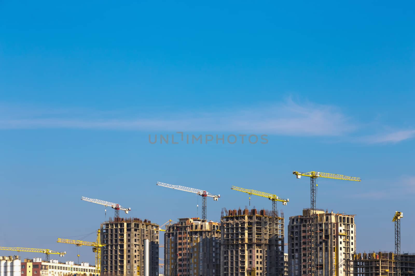 Building cranes on construction of city