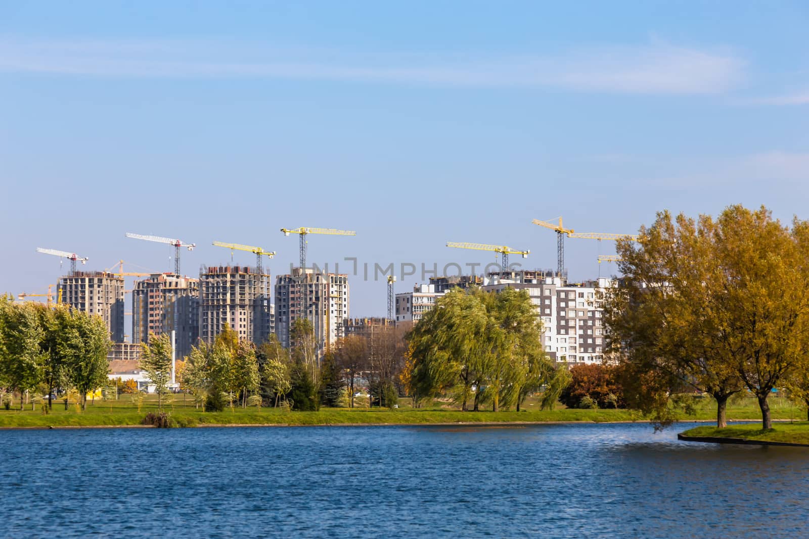 Building cranes on construction of city
