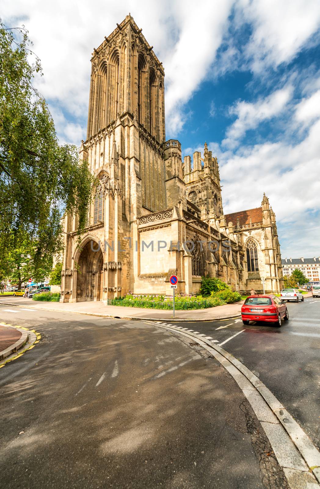 CAEN, FRANCE - JUNE 12, 2014: Eglise de Saint Jean on a cloudy day. Caen attracts more than 3 million people annually.