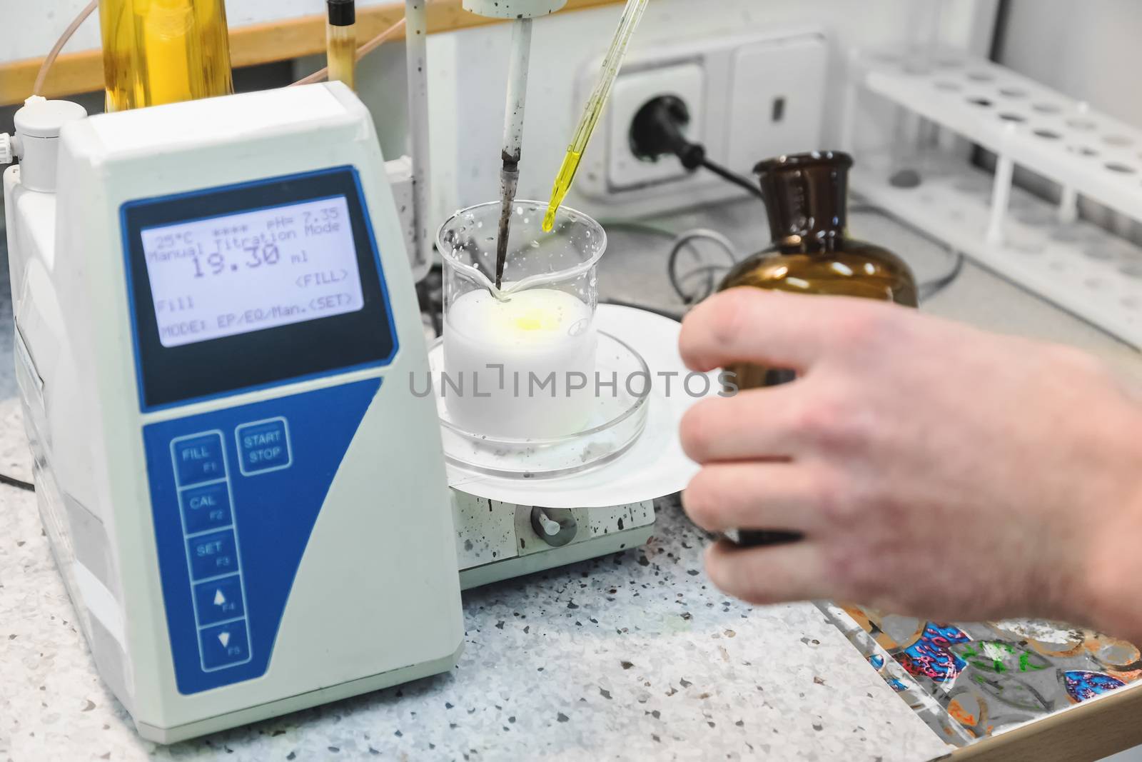 Laborant makes test in research laboratory with electronic measuring equipment on pharmaceutical industry manufacture or chemical plant