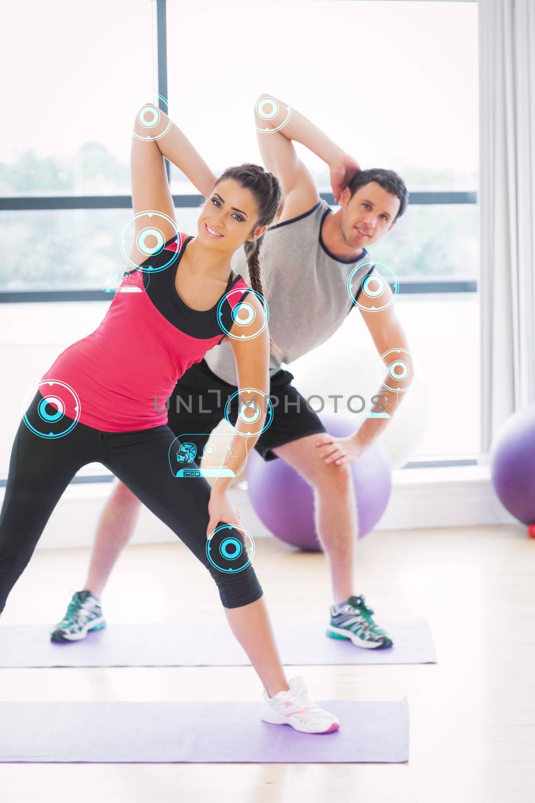 Two people doing power fitness exercise at yoga class against fitness interface