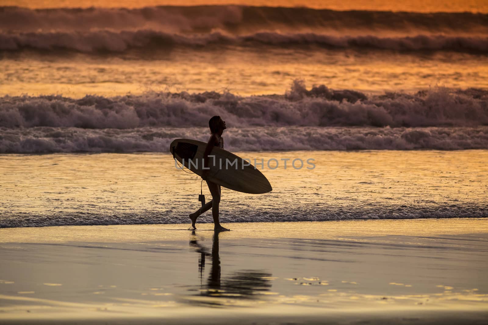 Surfer on the Beach at Sunset Tme by truphoto