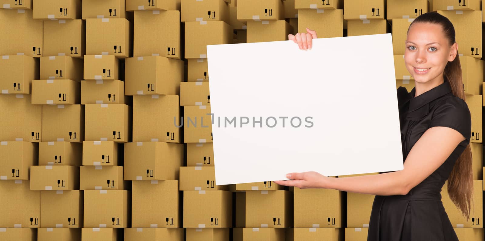 Smiling businesswoman with blank paper on ardboard boxes set background