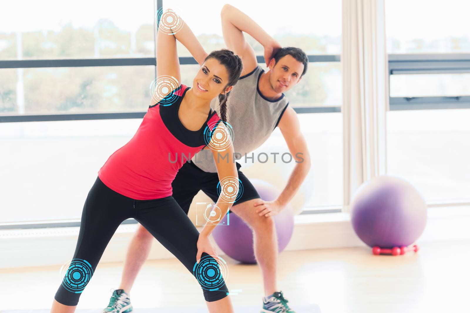 Composite image of two people doing power fitness exercise at yoga class by Wavebreakmedia