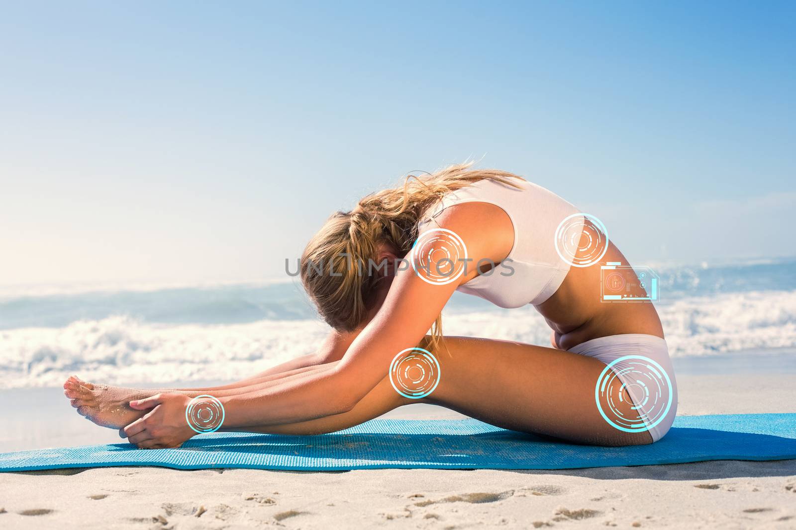 Composite image of gorgeous fit blonde in seated forward bend pose on the beach by Wavebreakmedia