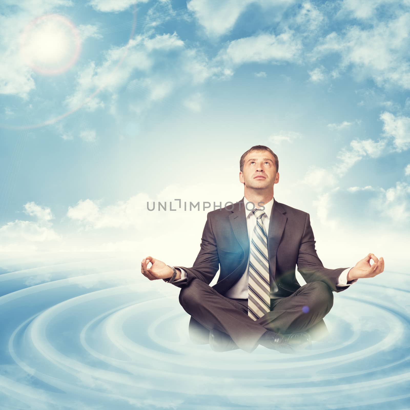 Businessman sitting in lotus position on circles by cherezoff