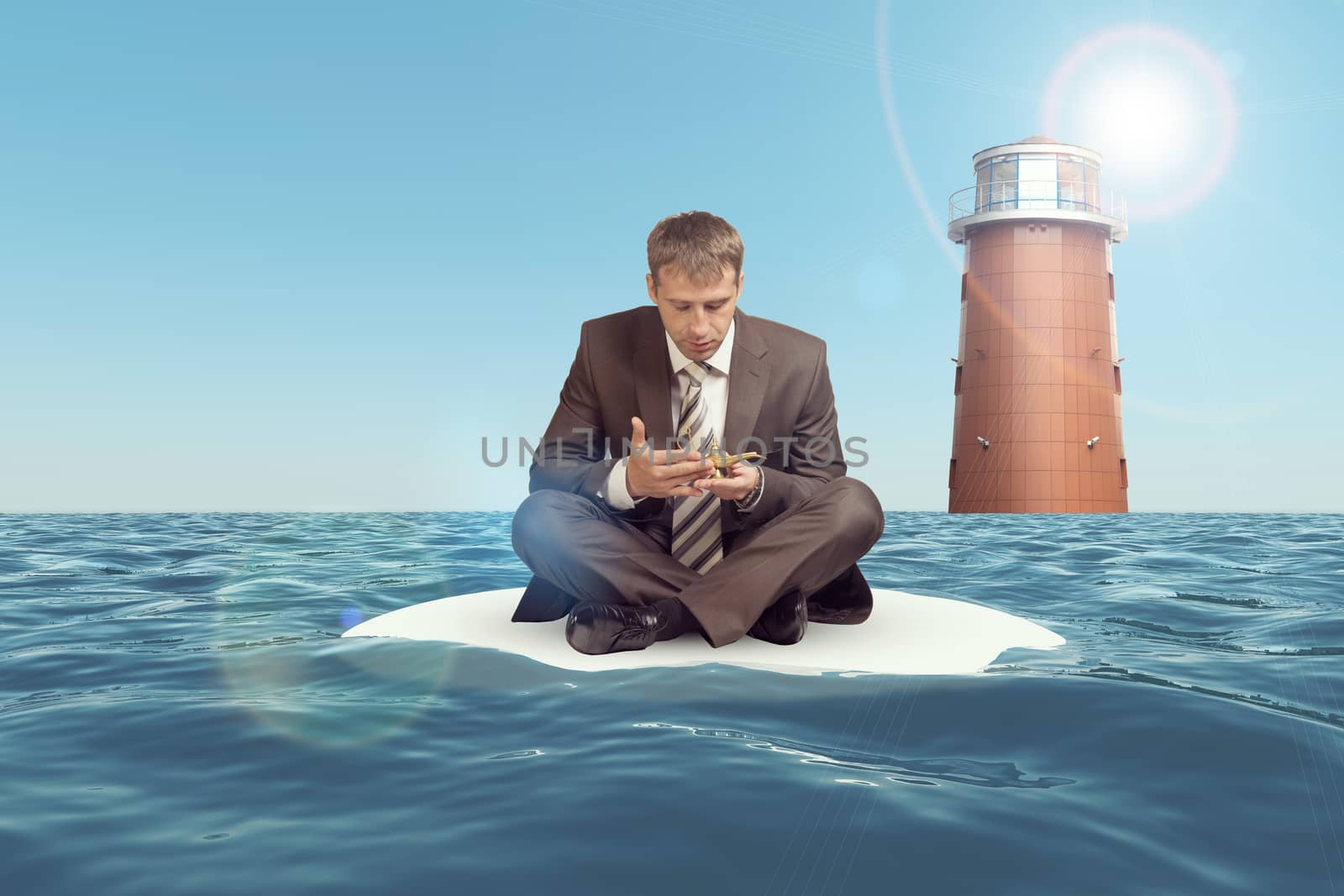 Businessman sitting in lotus position on small sand island in sea and looking at oil lamp