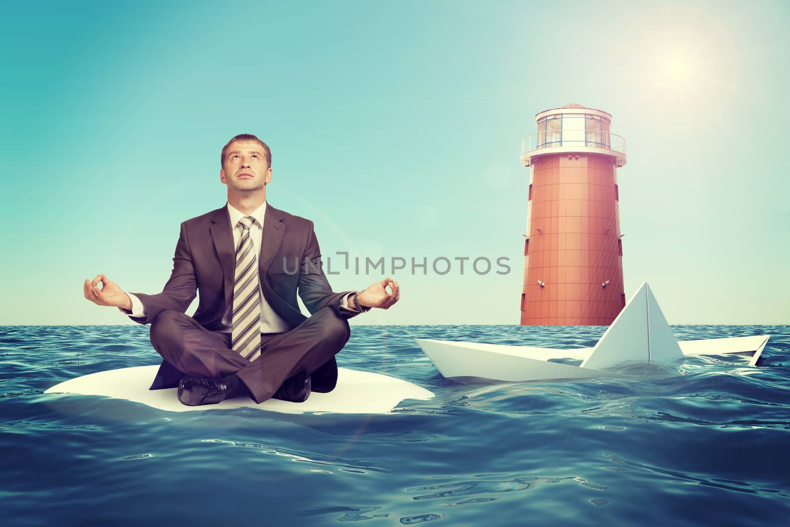 Businessman sitting in lotus position on small sand island in sea and looking up, sinking paper boat