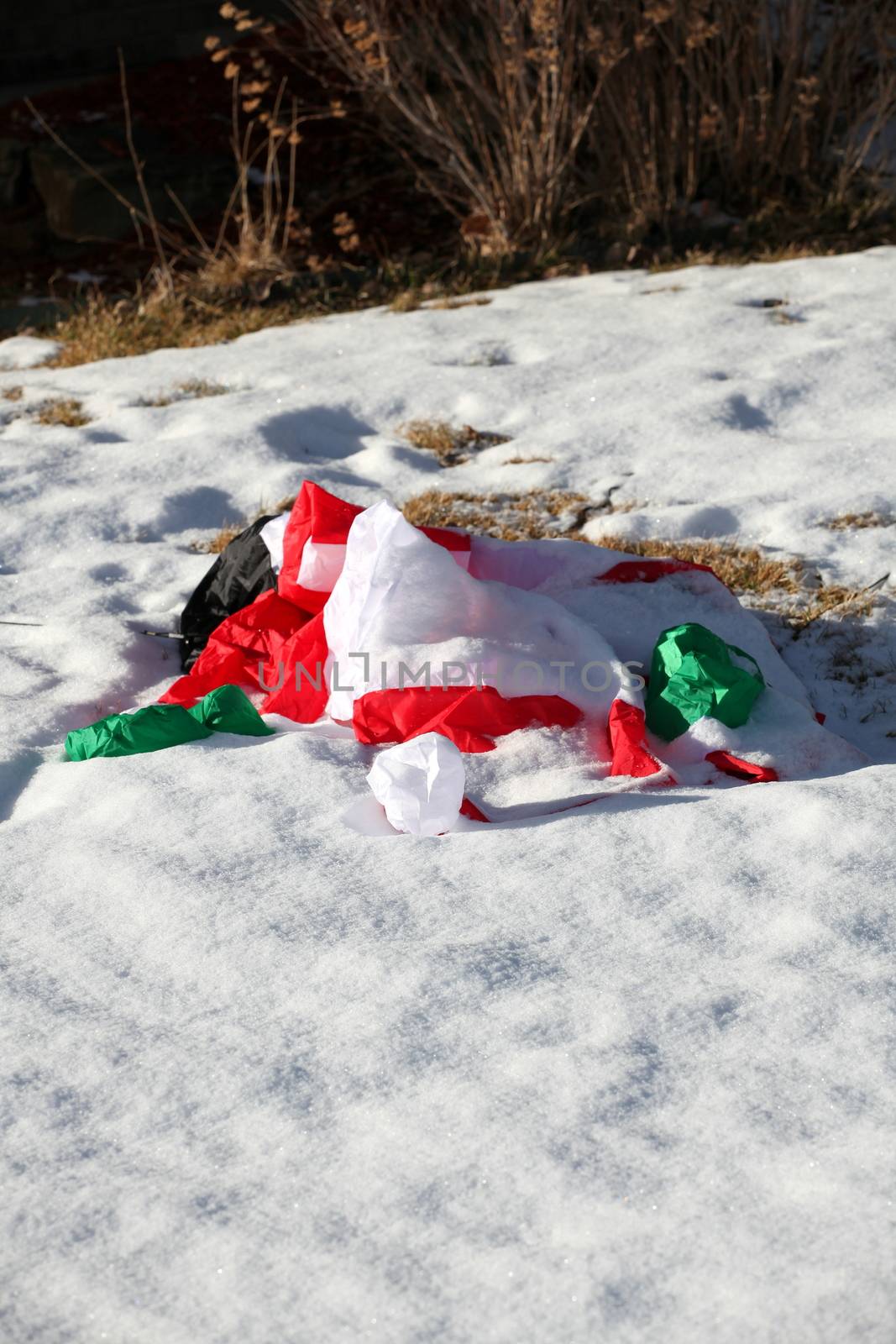 Santa claus collapsed in the winter snow.