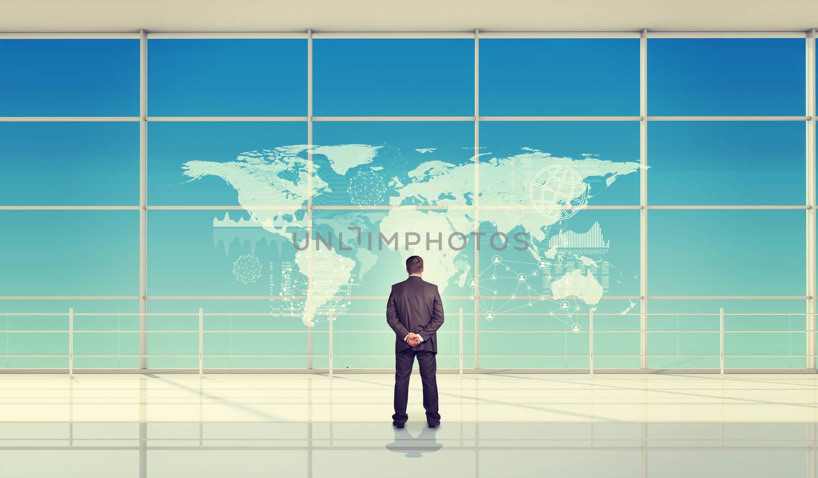 Businessman standing with hands behind, rear view. Abstract blue background with virtual world map