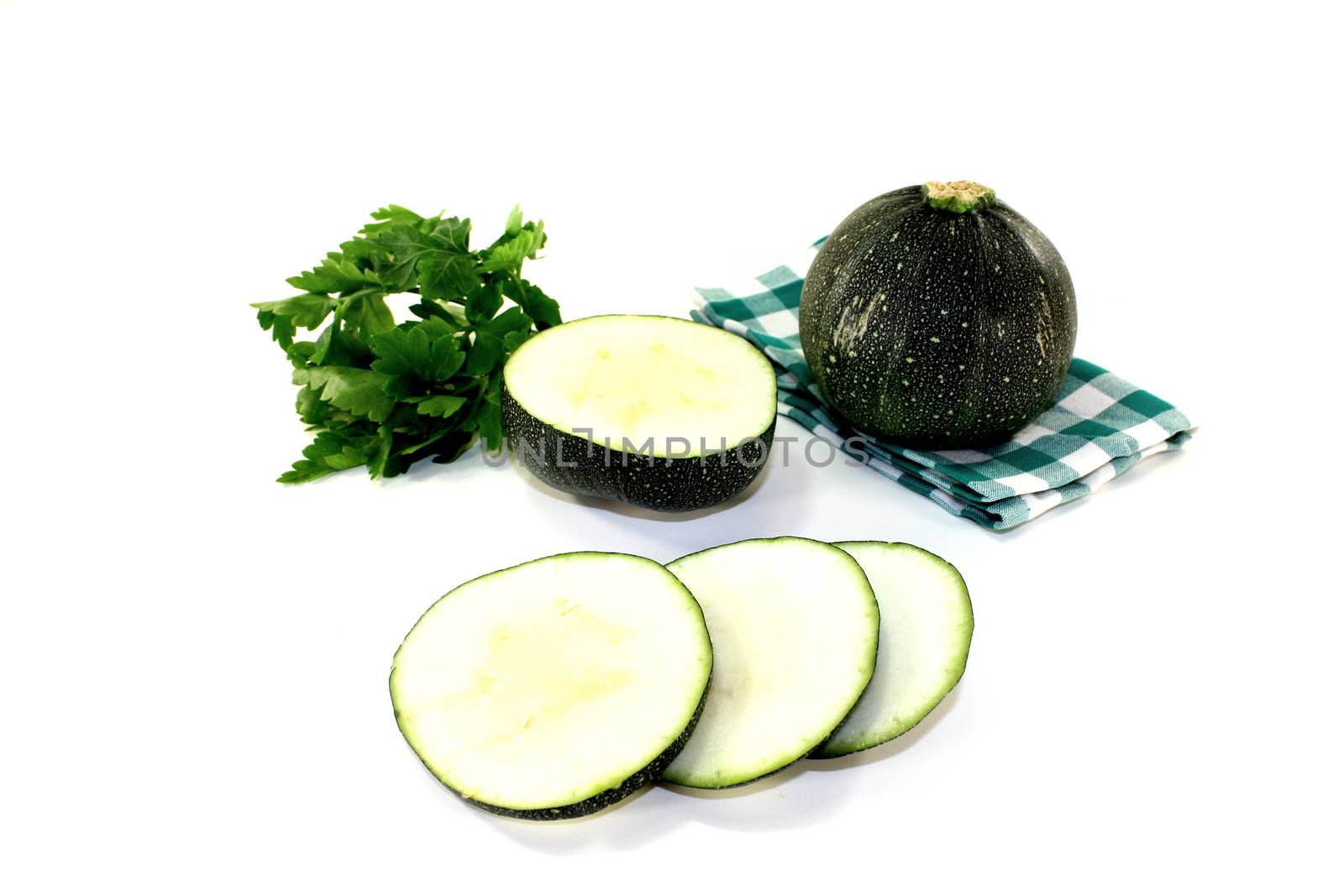 rotund raw zucchini on a napkin on a bright background