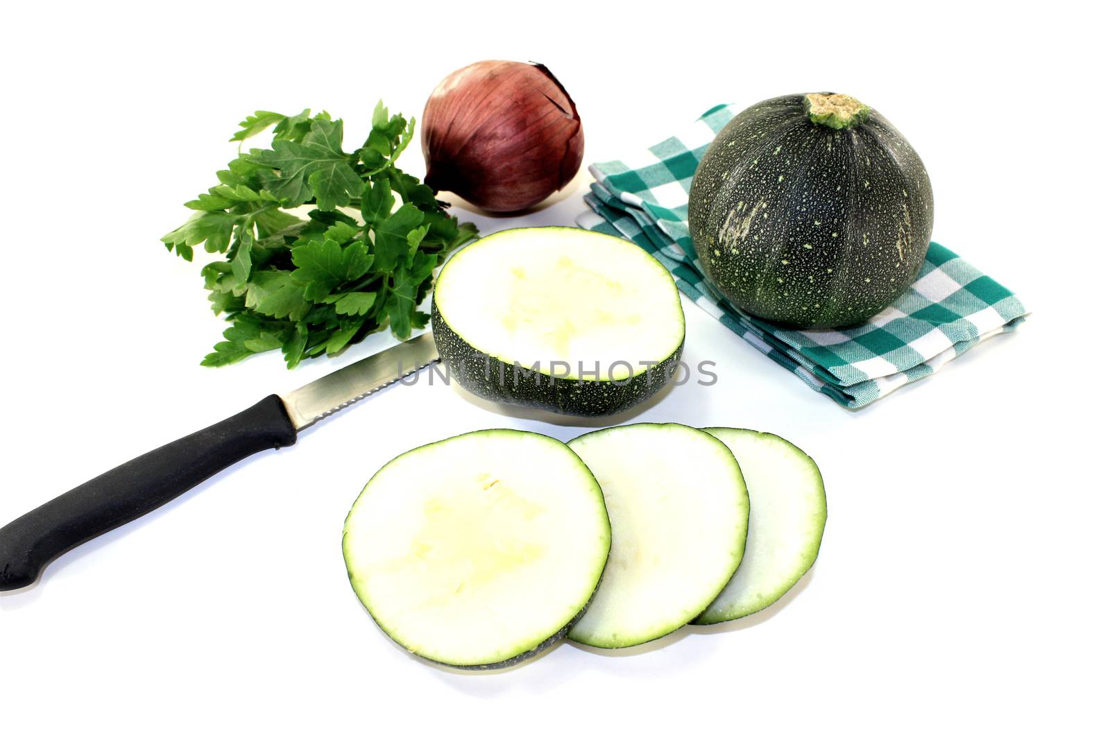 rotund raw zucchini with onion on a light background