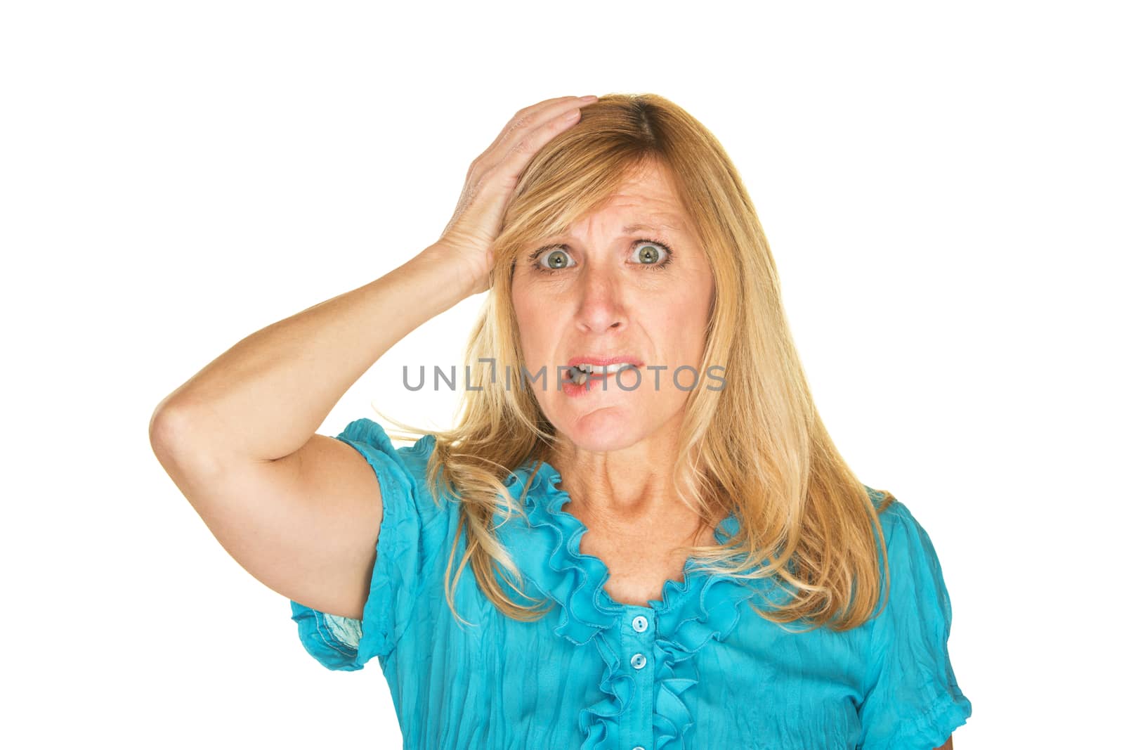 Overwhelmed female in blue biting lip with hand on head