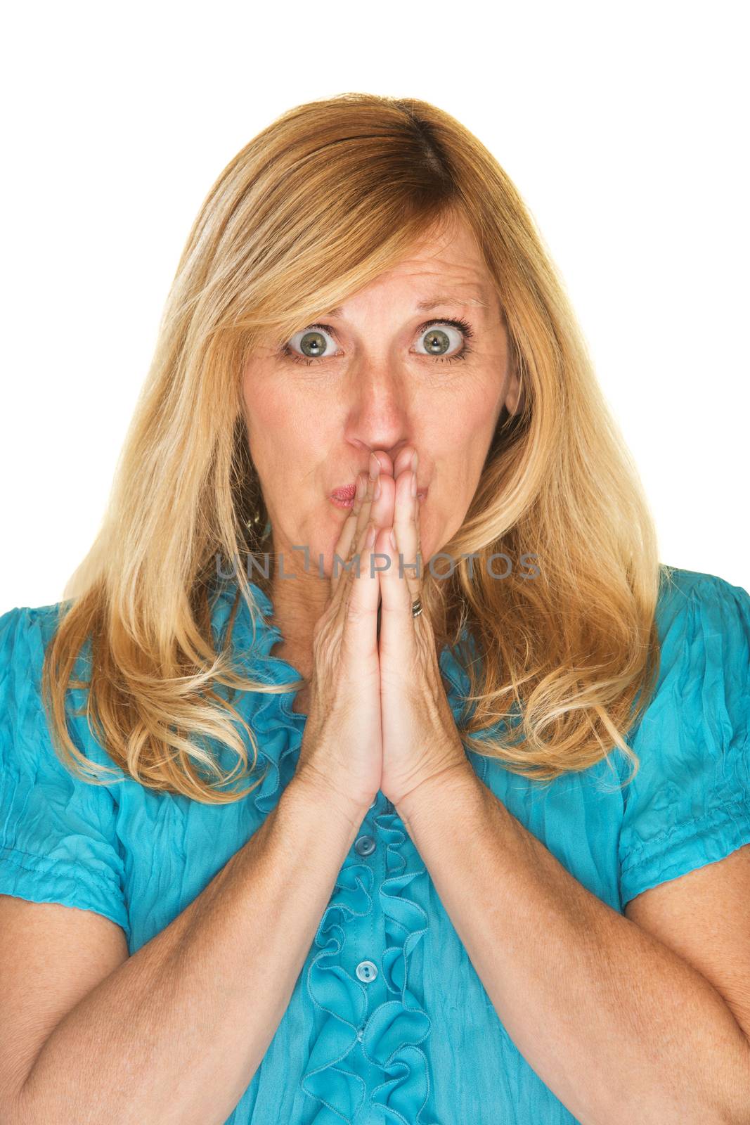 Wishful blond woman with hands together in suspense