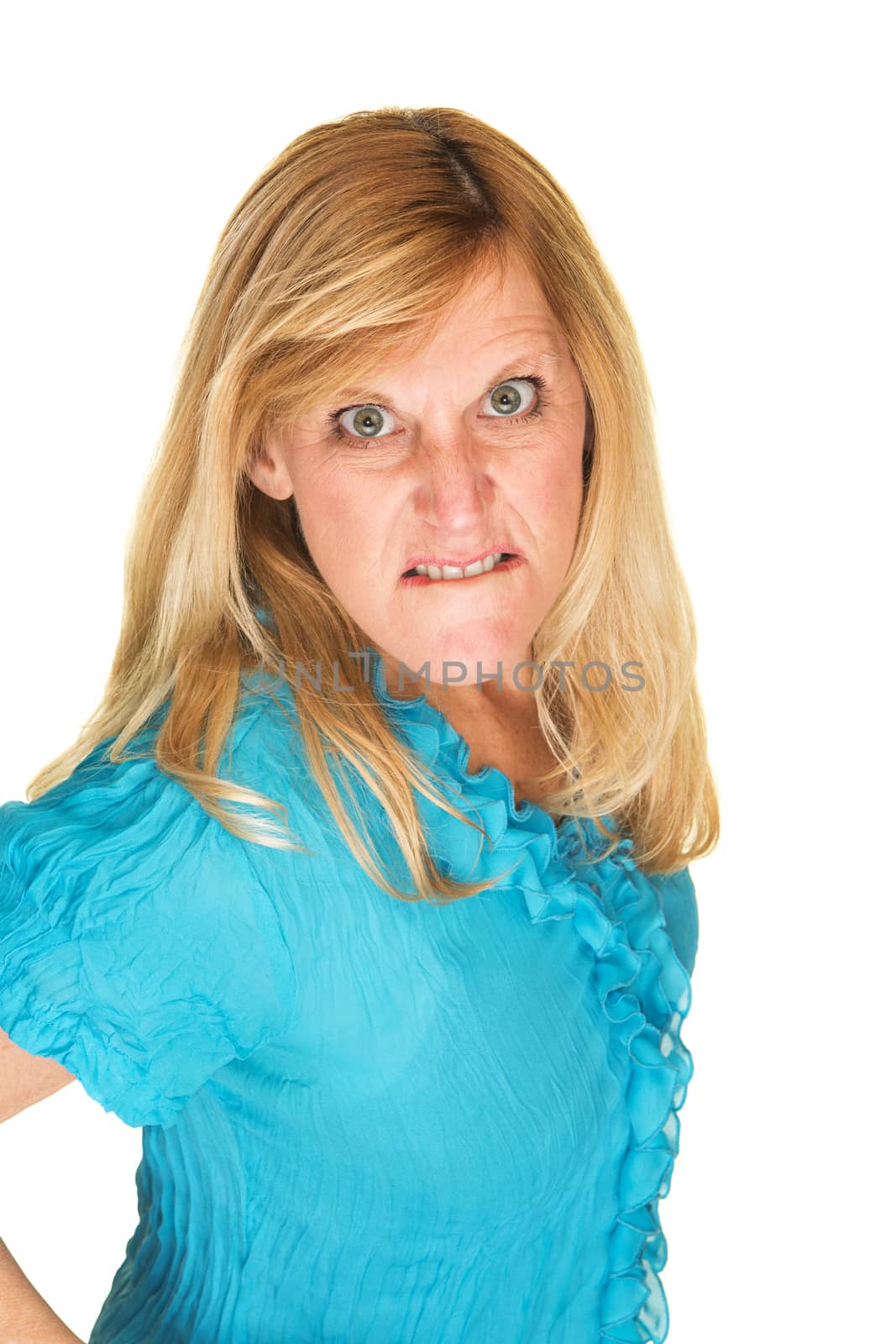 Furious European woman in biting lips over white background