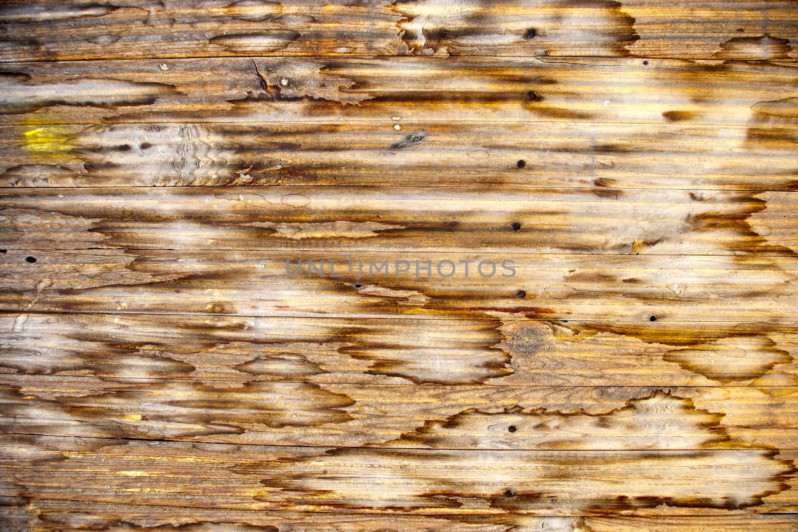 Dirty, stained by a paint the hammered together fence