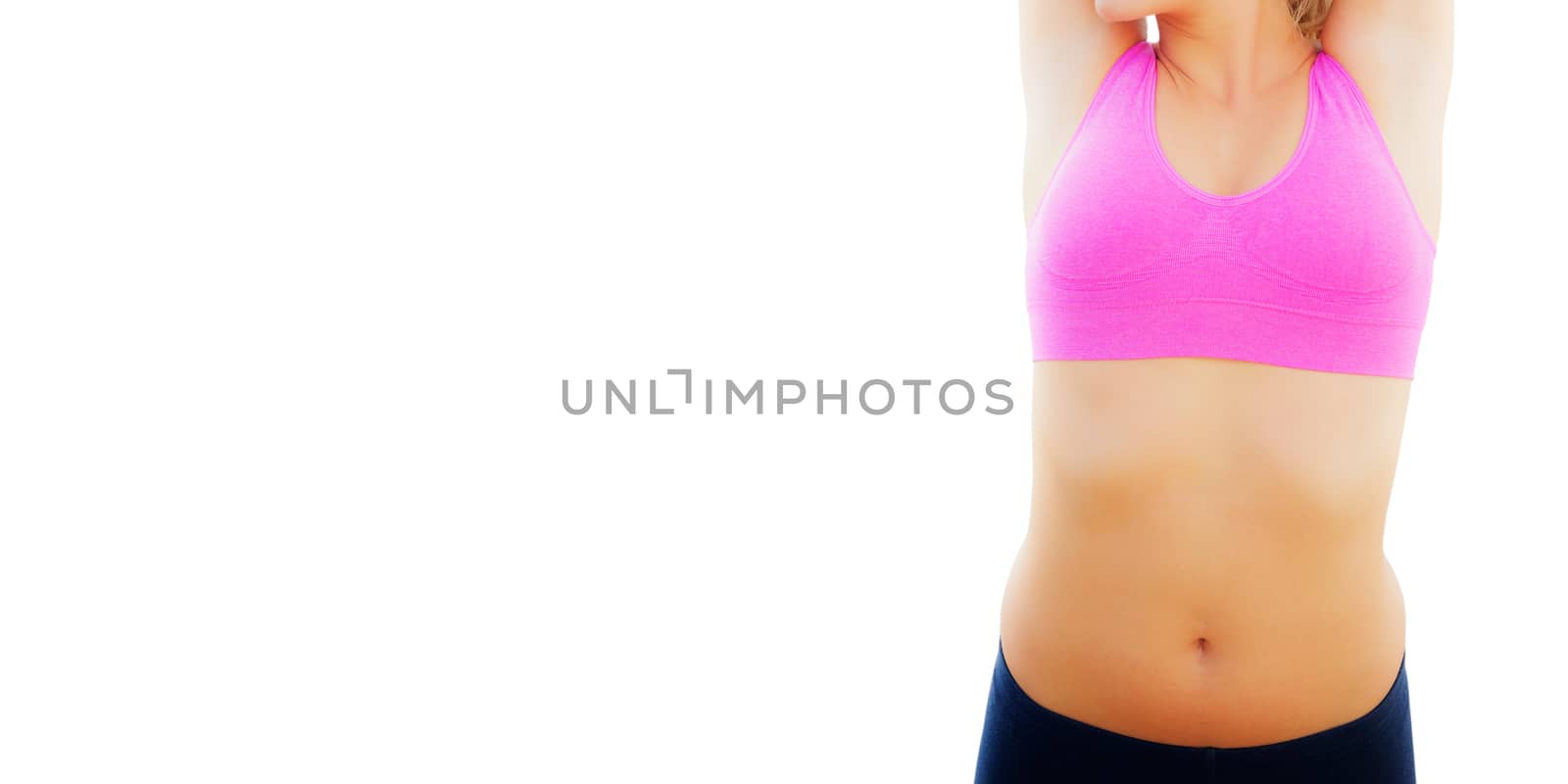 Smiling toned woman stretching hands on beach by Wavebreakmedia