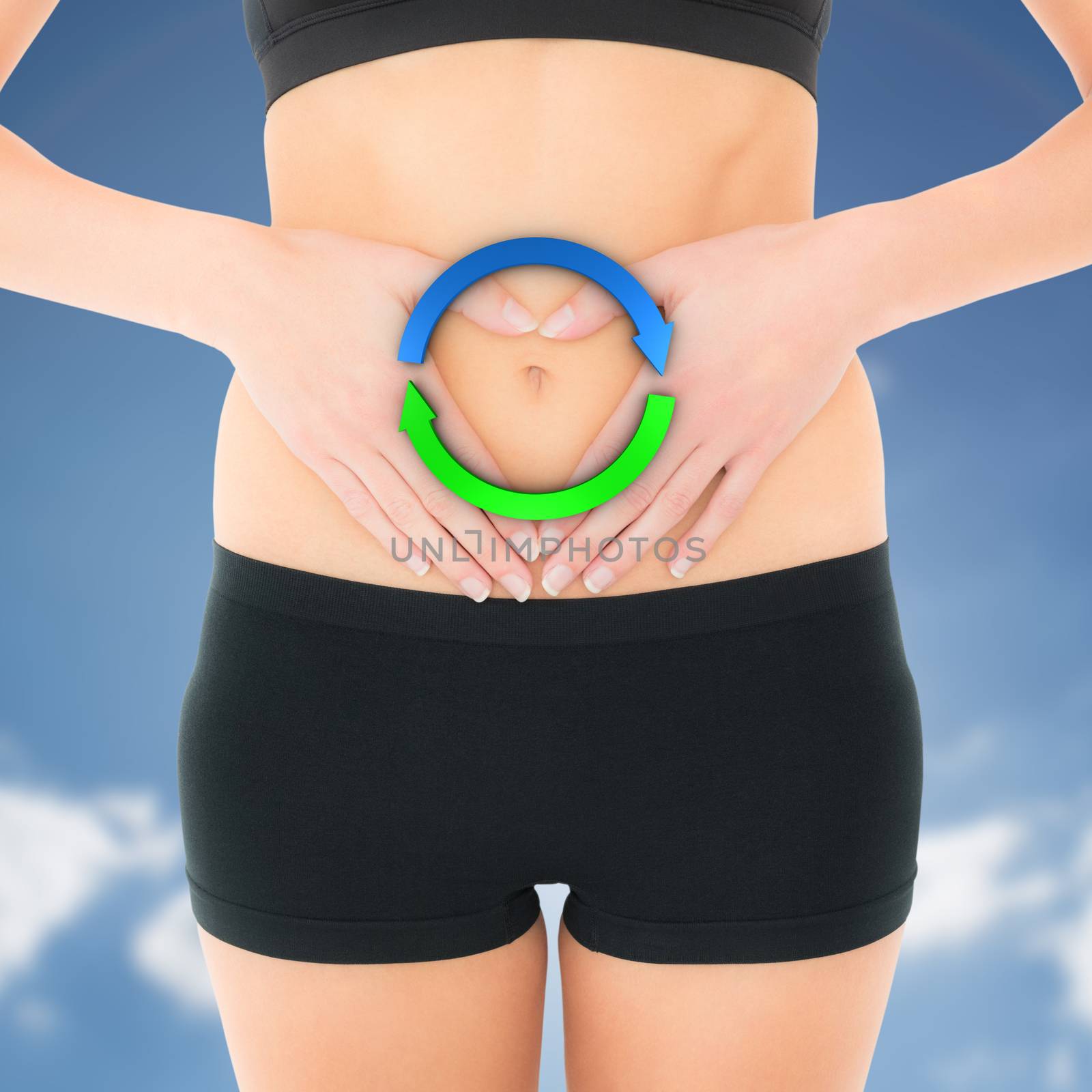 Closeup mid section of a fit woman in black shorts against cloudy sky with sunshine