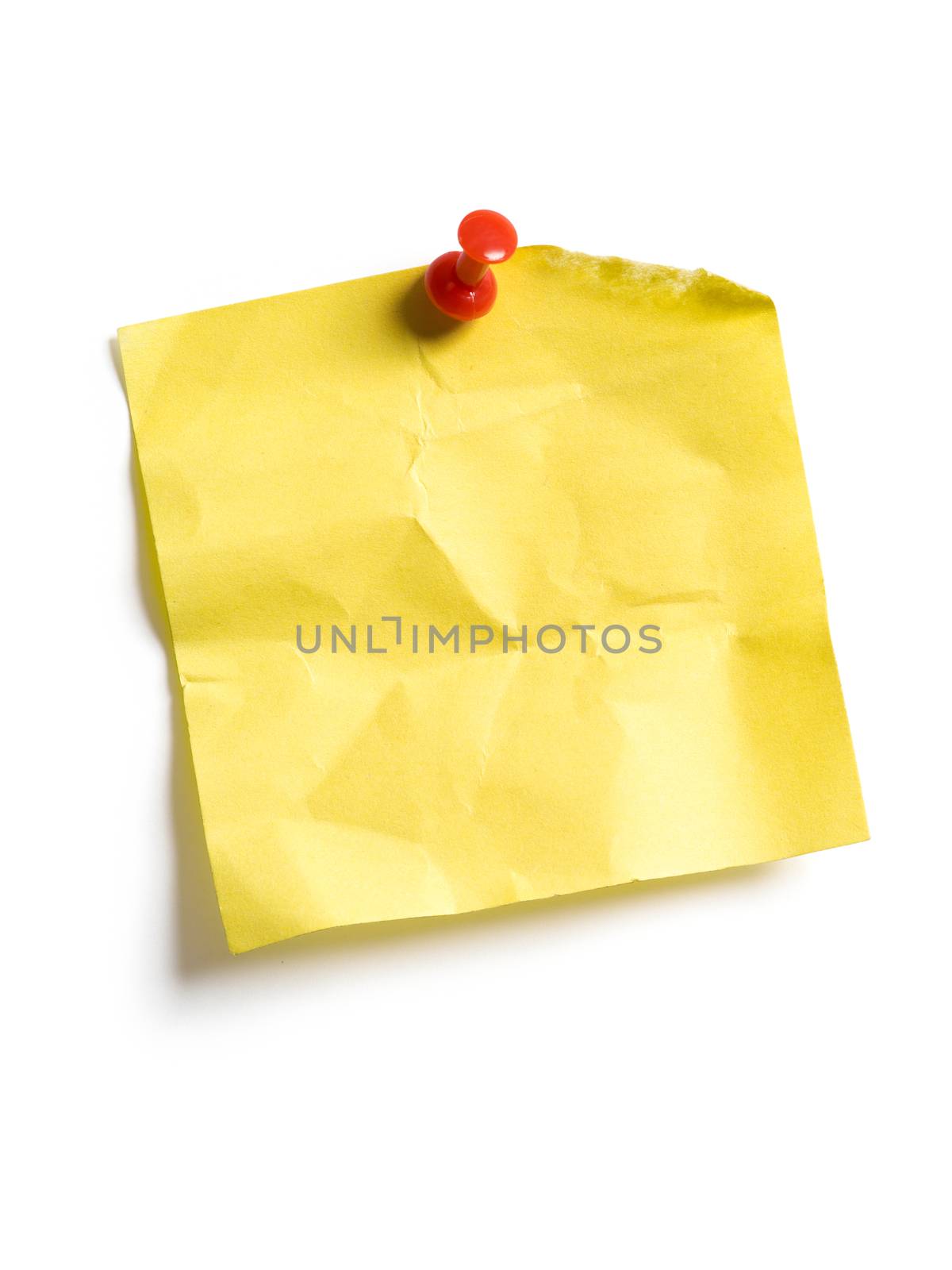 Photo of an isolated yellow sticky note pinned to a white background.