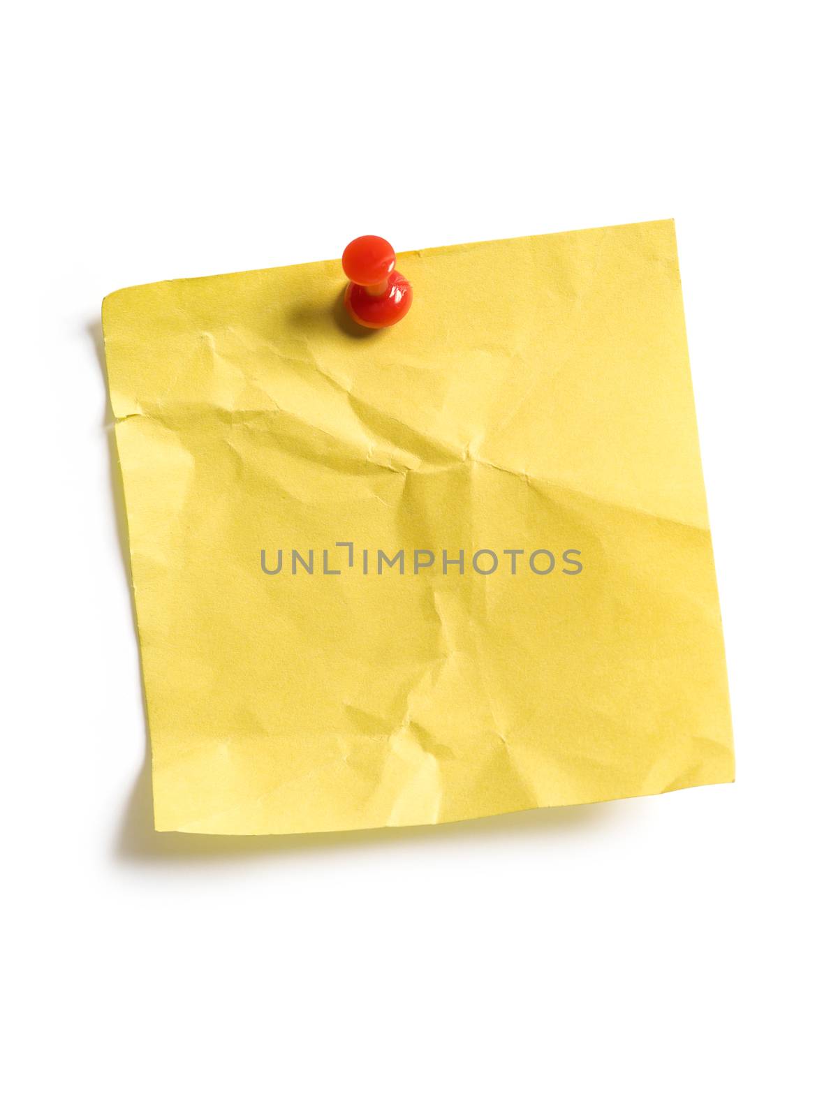 Photo of an isolated yellow sticky note pinned to a white background.