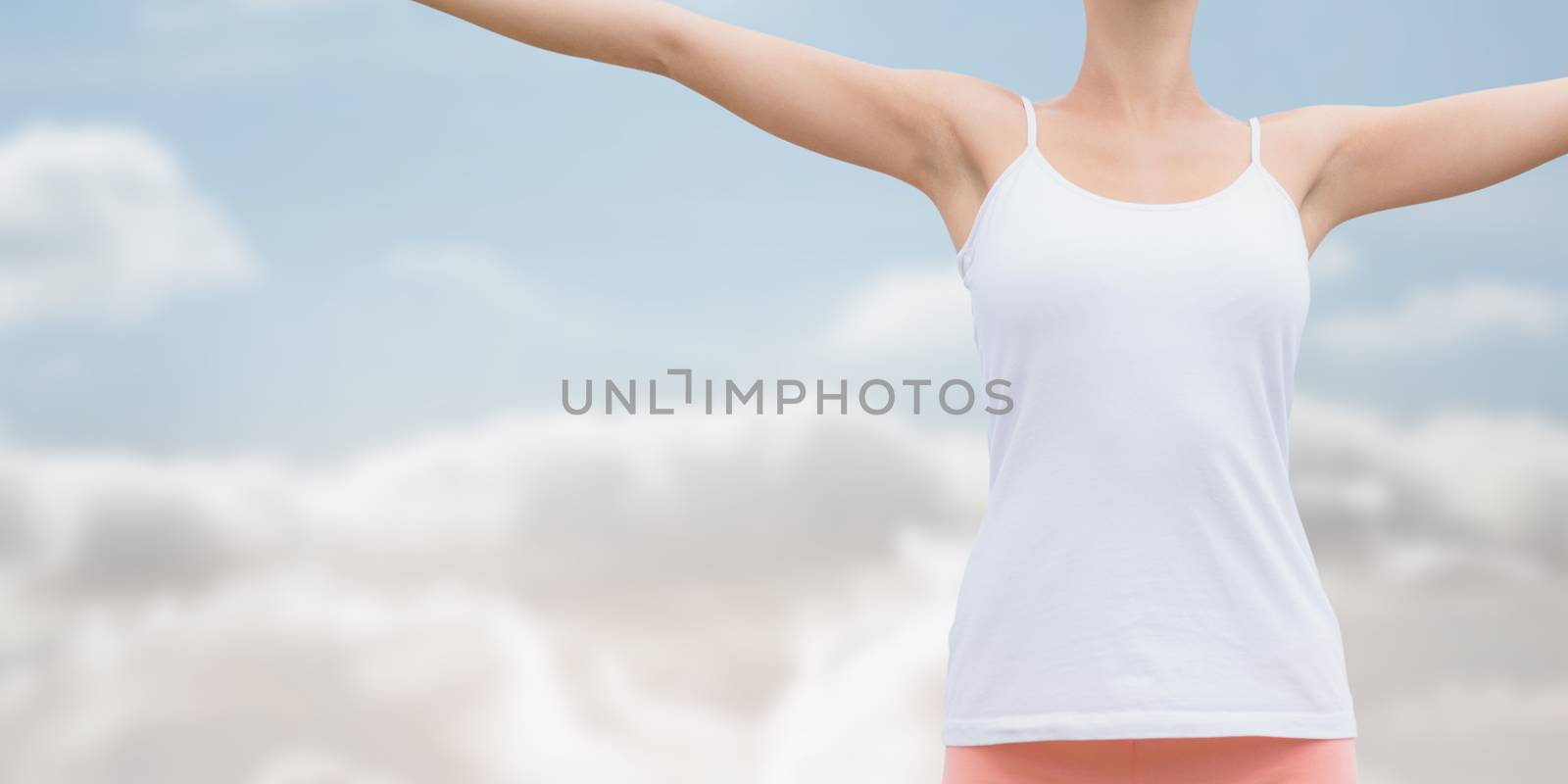 Composite image of beautiful woman with arms raised against the sky by Wavebreakmedia