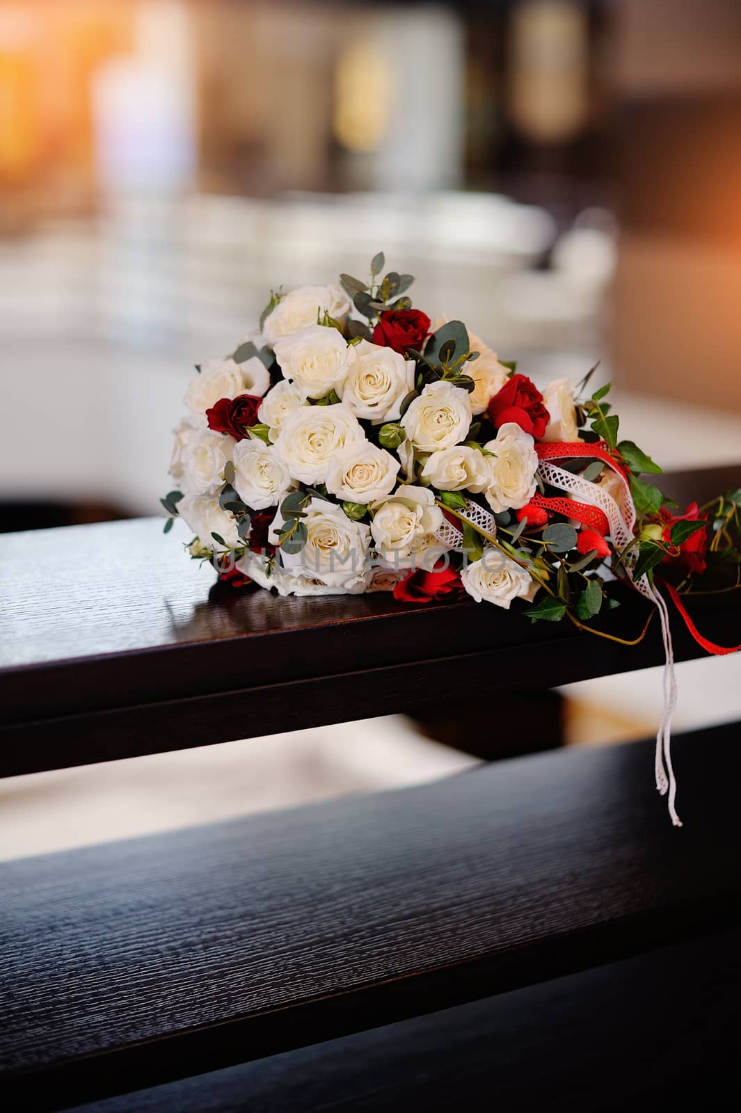 bridal bouquet of roses on a wood table.