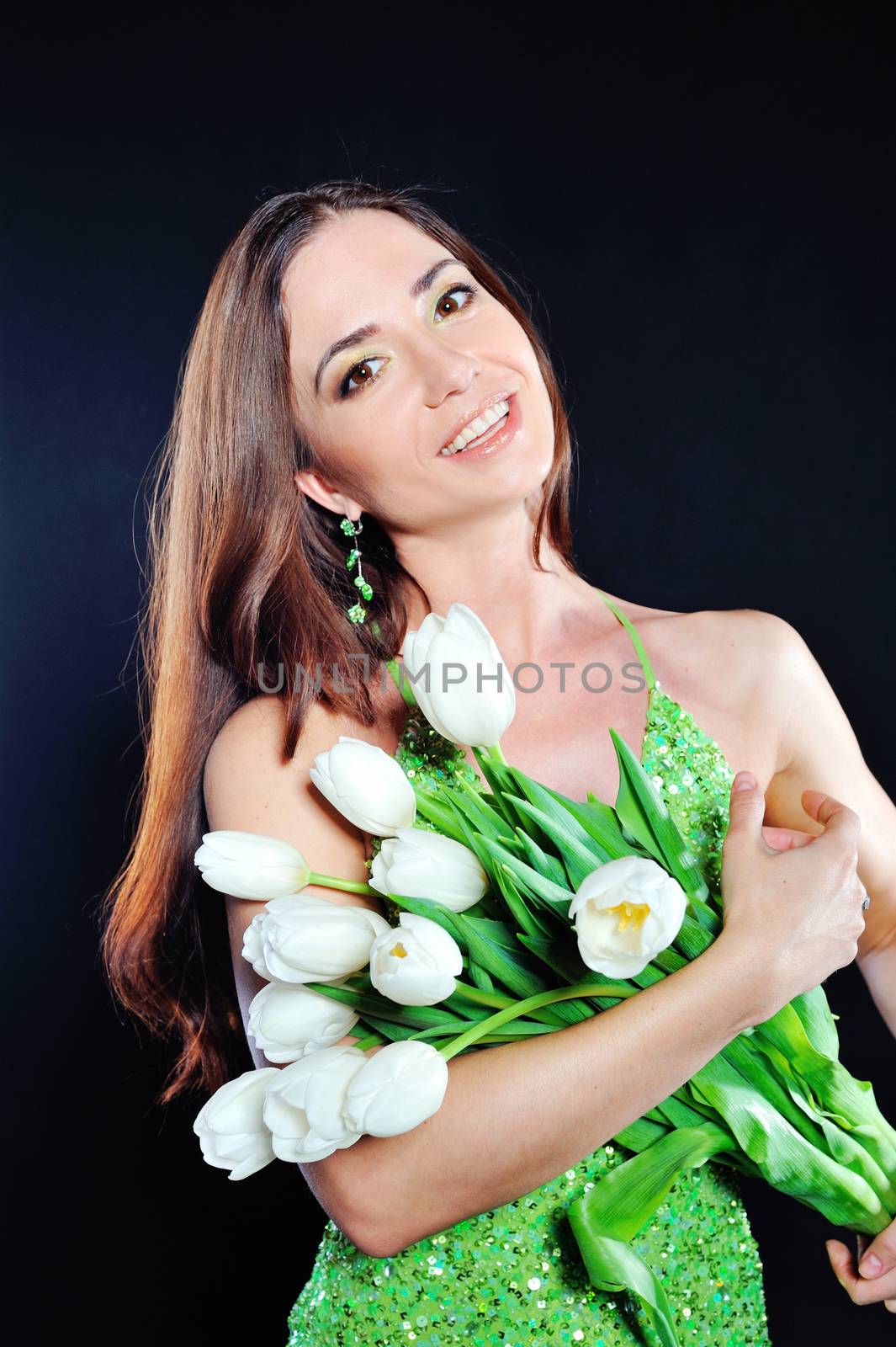 Portrait of a smiling girl with tulips in spring.