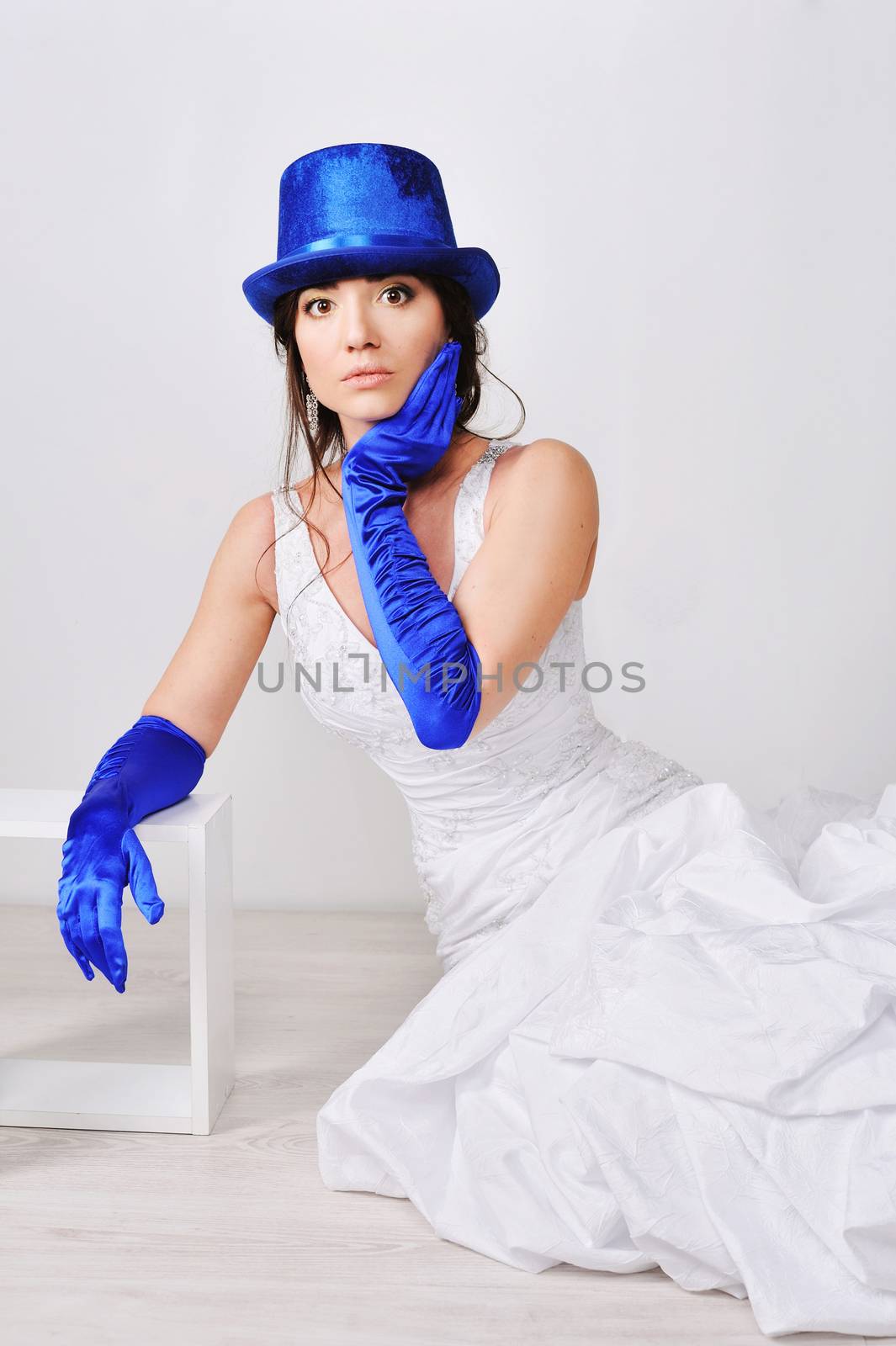 Frightened, surprised the bride in blue gloves and hat.