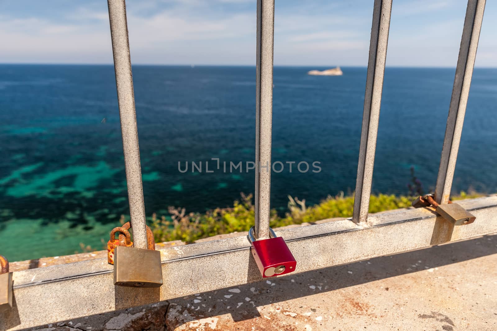 Metal padlock - memory locks on the bridge, symbols of love against the background of the sea