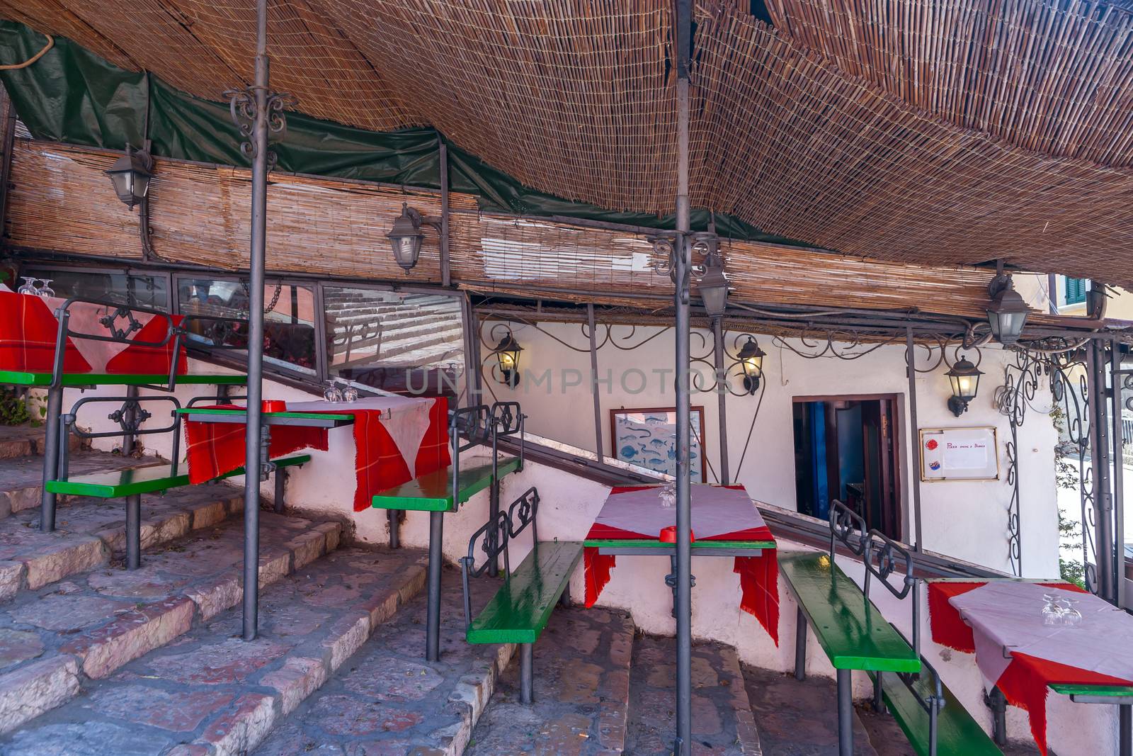 Italian outdoor cafe on the stairs under a canopy