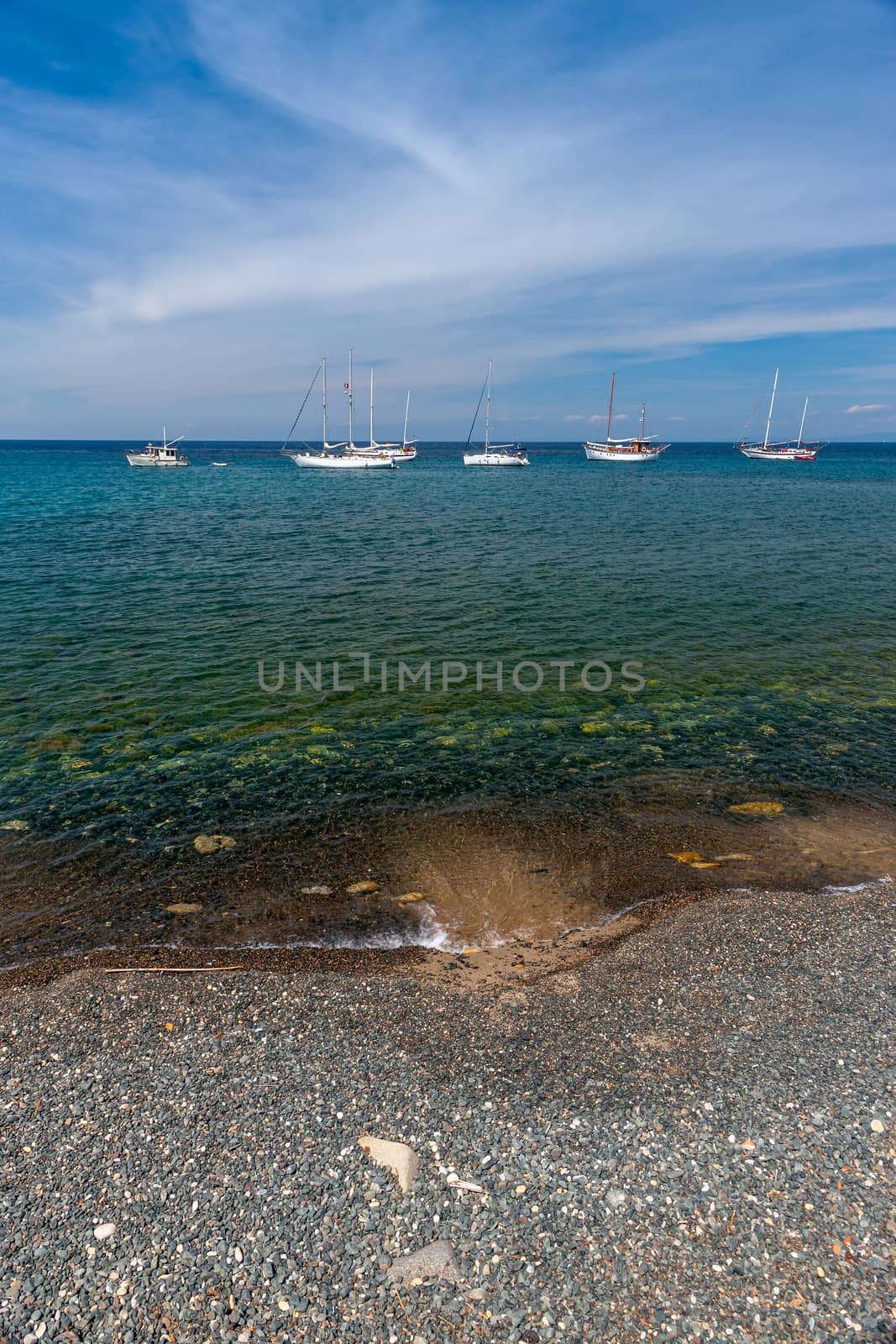 beautiful seascape with ships and yachts and pebble beach