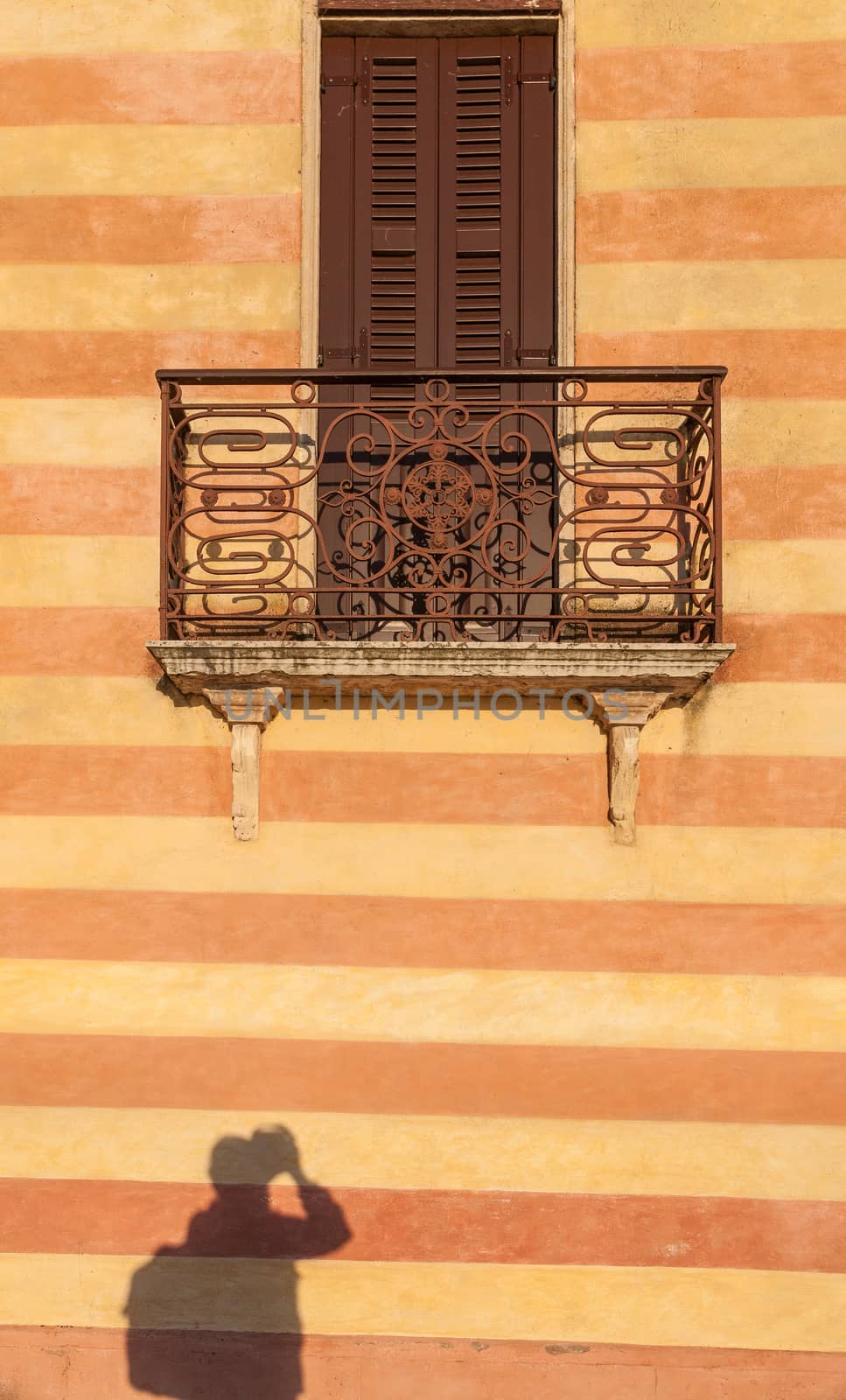 door with balcony in venetian style on Verona street, Italy