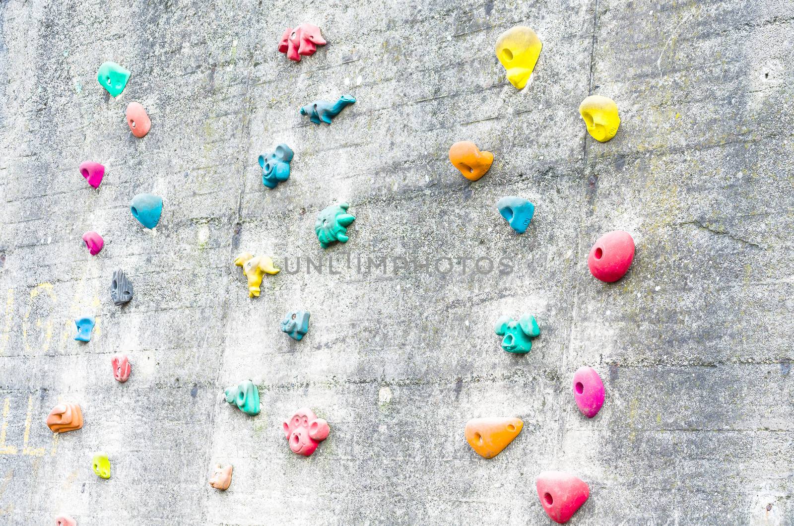 Detail climbing wall at an amusement park with climbing aids.