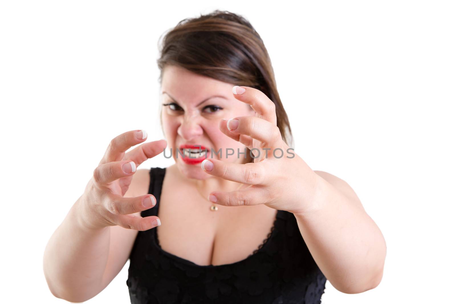 Furious temperamental woman clawing her hands and gnashing her teeth in a fit of temper and fury, isolated on white