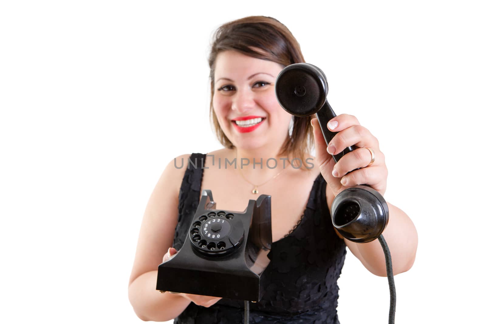 Friendly smiling woman holding out a telephone by coskun